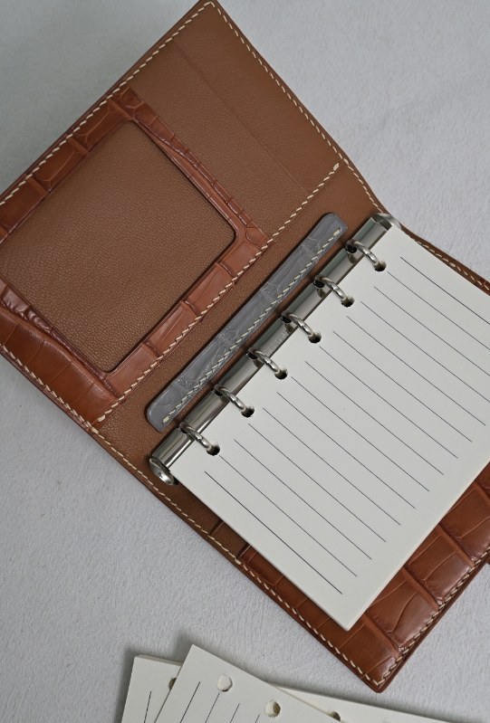 Open leather organizer with compartments visible for a product brief