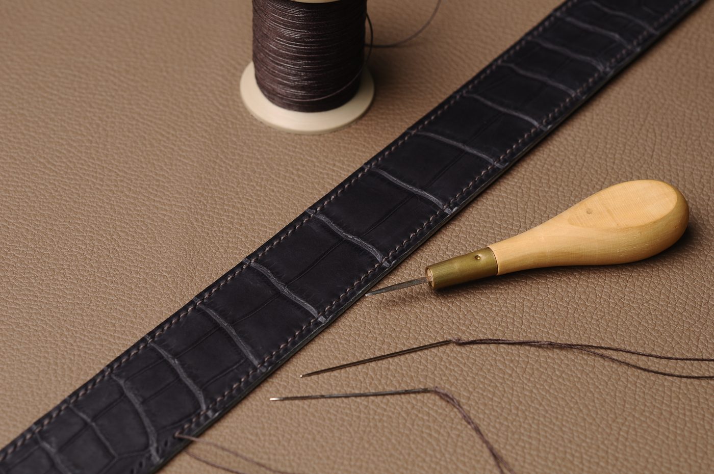 Close-up of black leather belt texture and stitching