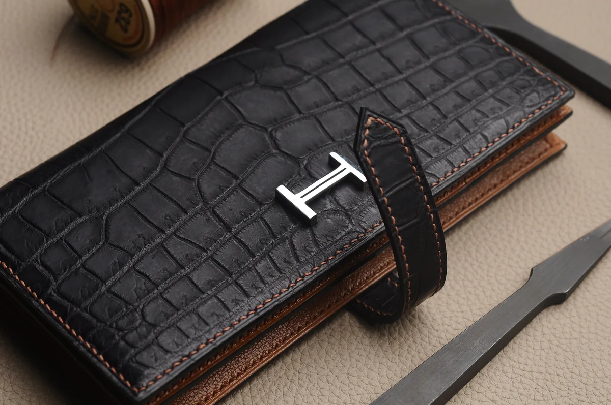 Metal logo detail on textured leather