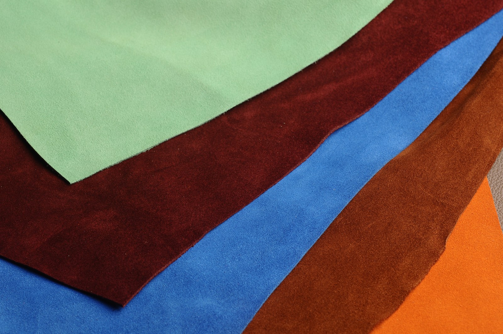 Layered green, burgundy, blue and orange cut material panels